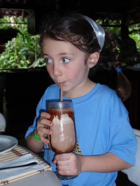 Emma slurping her favorite Costa Rican beverage, a "chocolate frio."